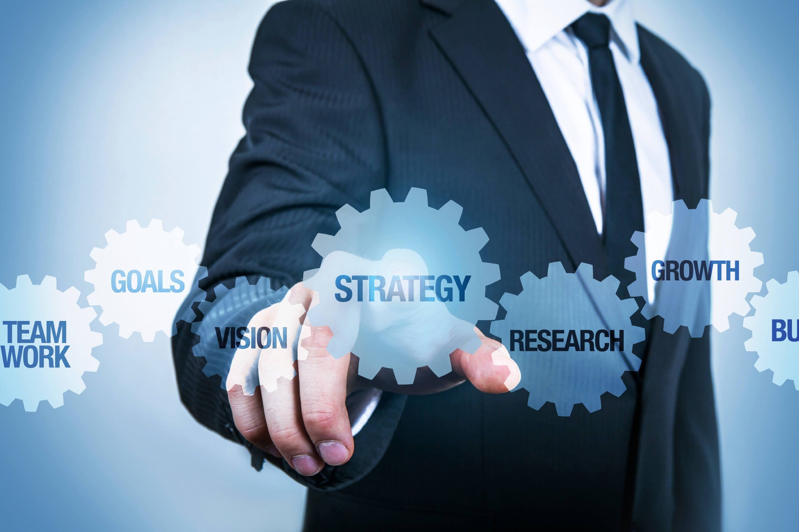 Businessman pointing at strategy gear concept.