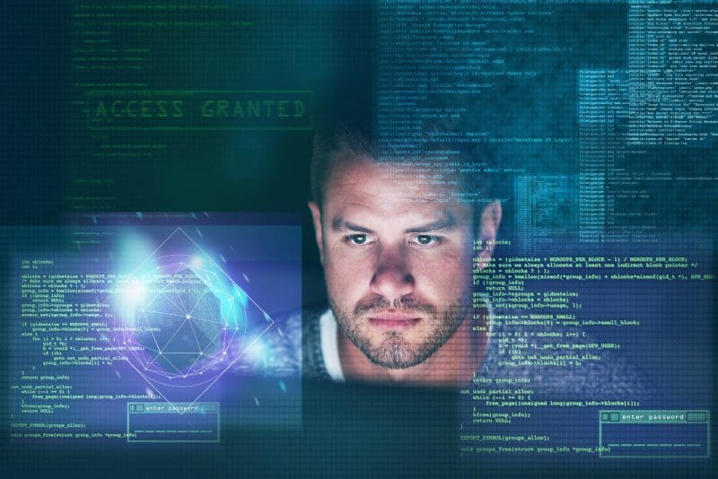 Man surrounded by digital code and graphics.